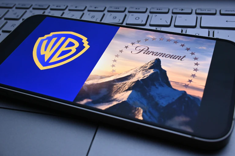 Phone screen showing Warner Bros. and Paramount branding.