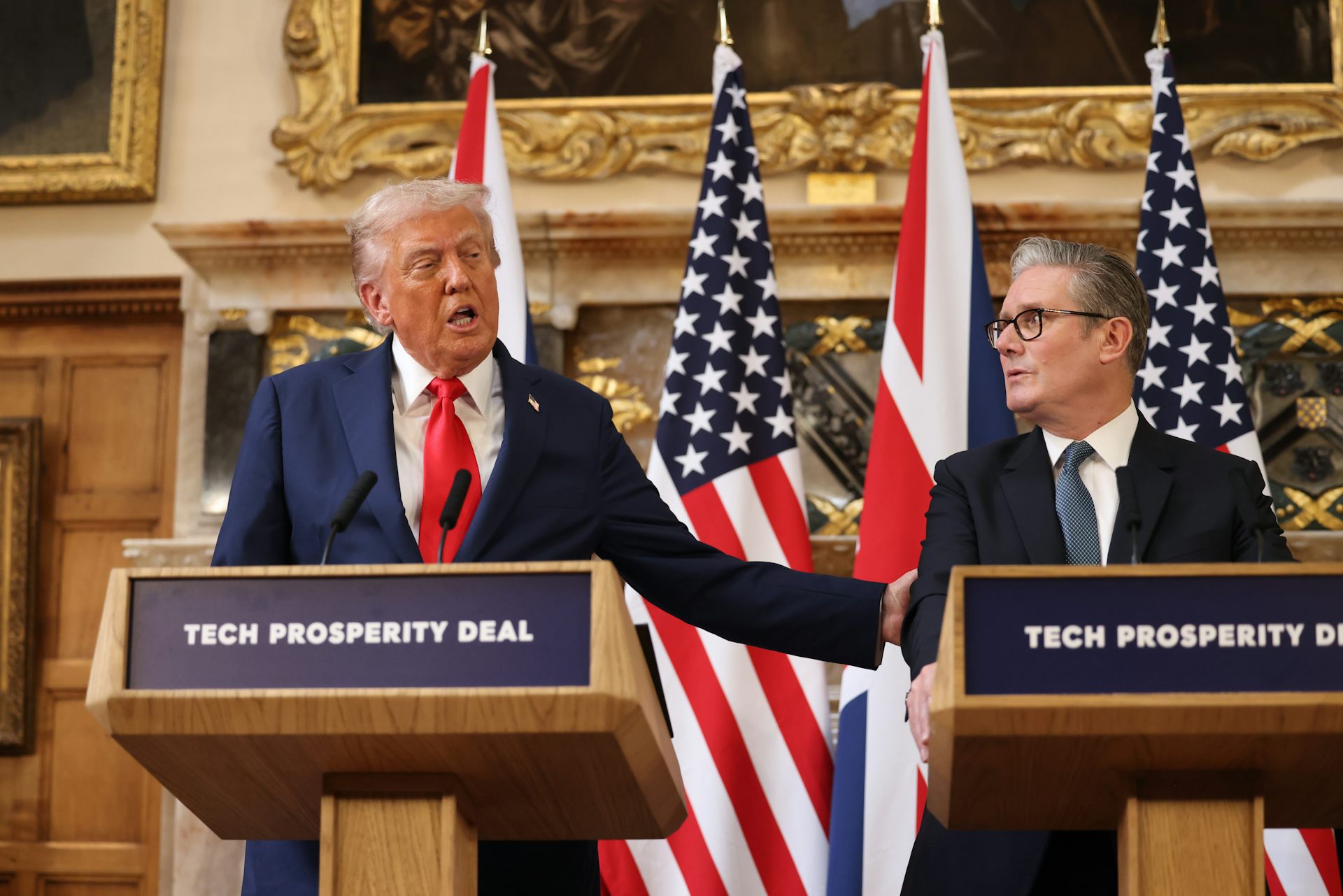 Trump and Starmer at podiums, Trump has his hand on starmer's shoulder and is speaking