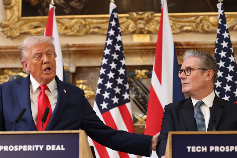 Trump and Starmer at podiums, Trump has his hand on starmer's shoulder and is speaking
