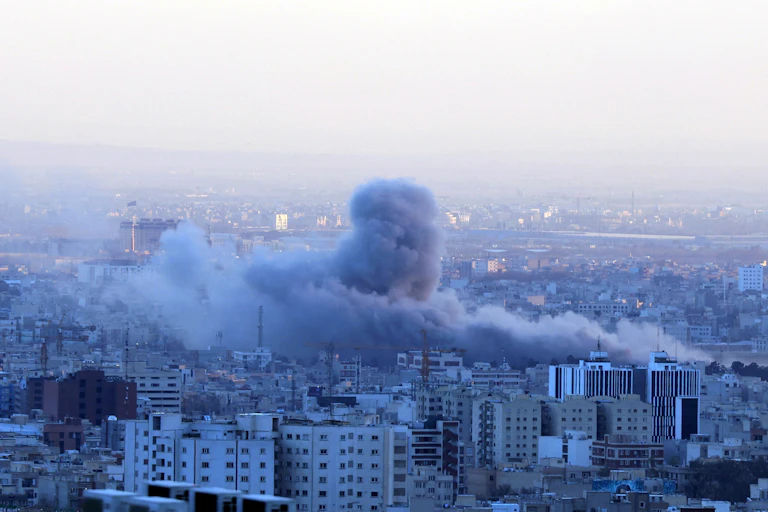 Smoke rises from central Tehran after an airstrike.