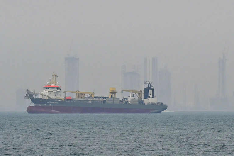 Ship with high-rise buildings in the background