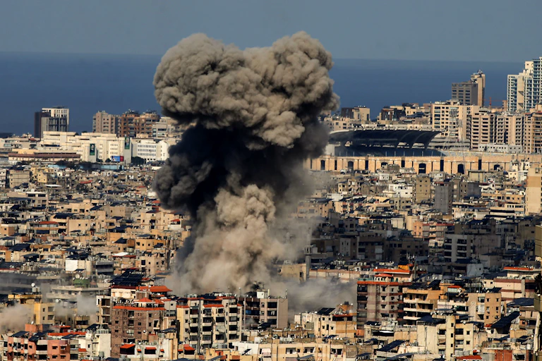 Black smoke rises above buildings