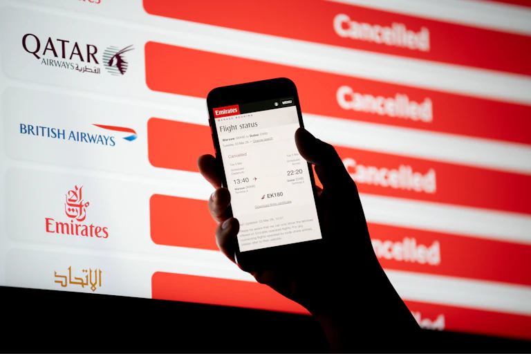 An electronic billboard with a list of cancelled flights to the Middle East.