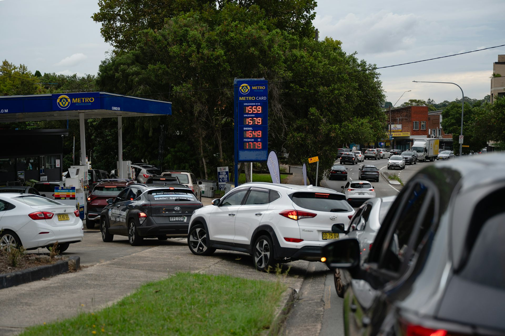 Cars queuing for petrol on a busy road