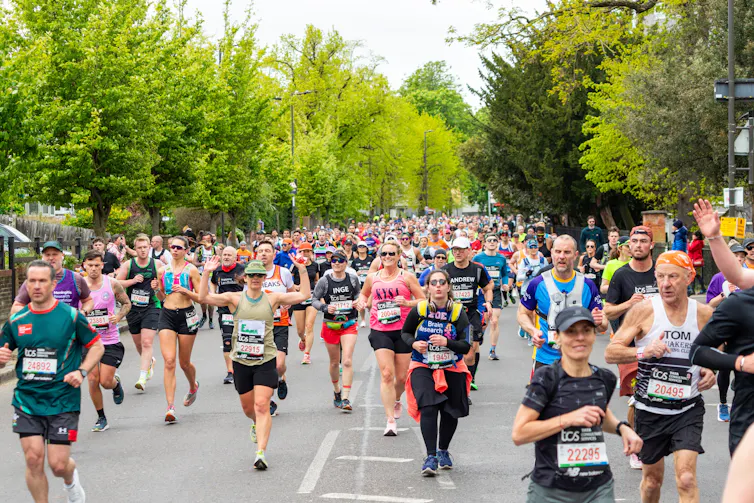 Groups of people running in the London Marathon.