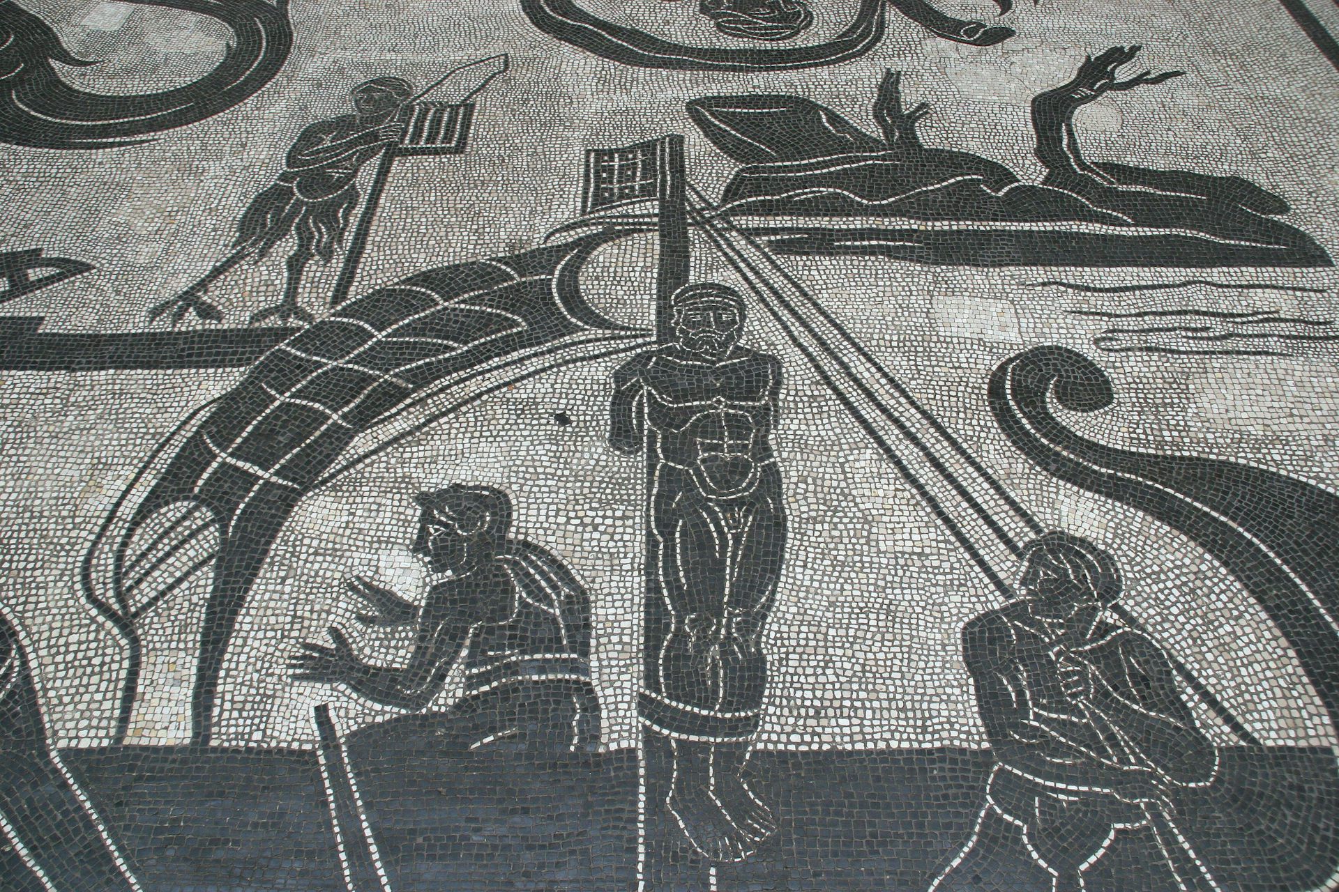 A black and white mosaic showing Odysseus tied to the mast of a ship resisting the Siren.