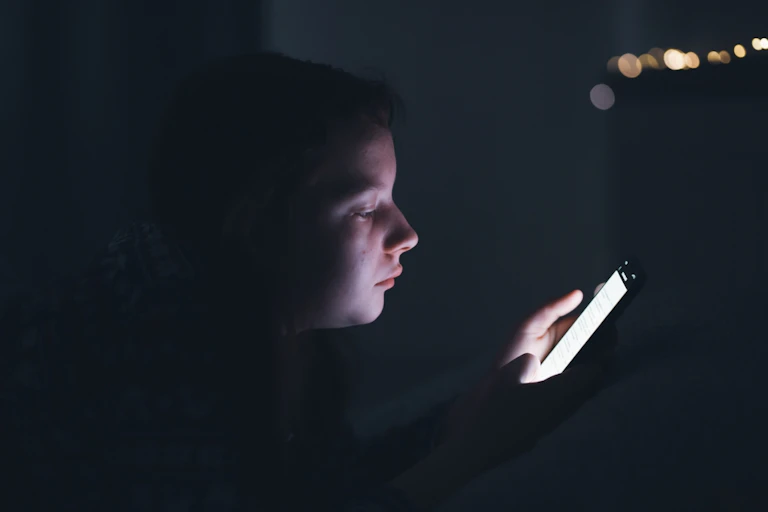 Une adolescente en train de consulter un smartphone.