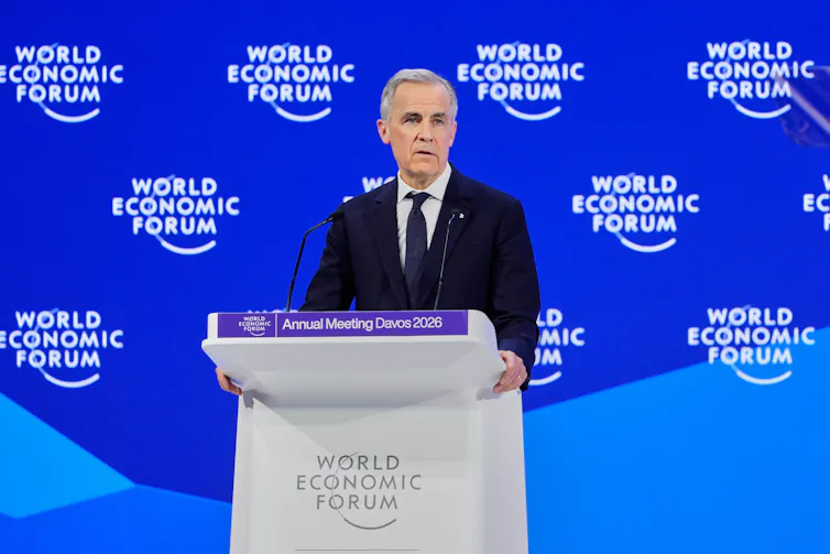 A politician gives a speech on a stage.