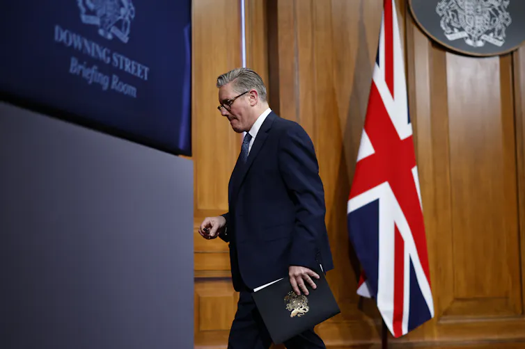 Starmer walking out of the Downing Street briefing room