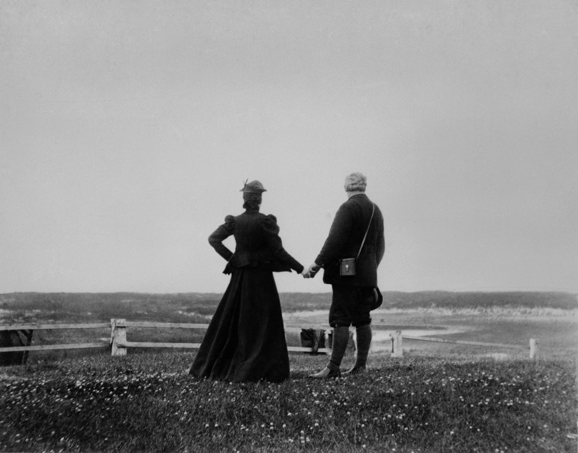 Alexander Graham Bell and Mabel Hubbard Bell stand looking out to sea in Canada, 1898.