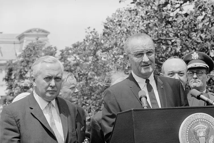 Lyndon B. Johnson with Harold Wilson in a garden at the White House.