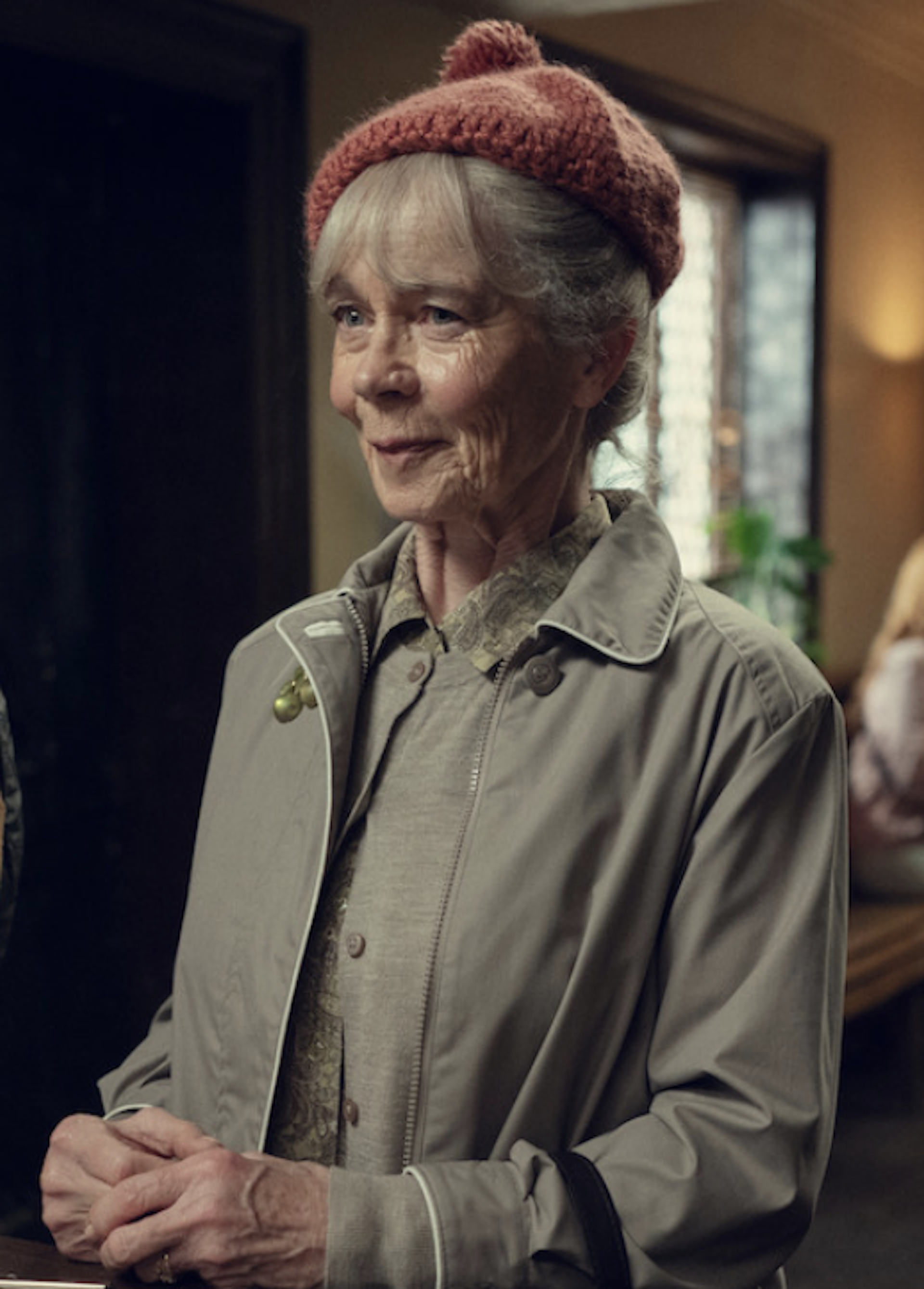 An elderly lady in a wee rust-coloured tammy.