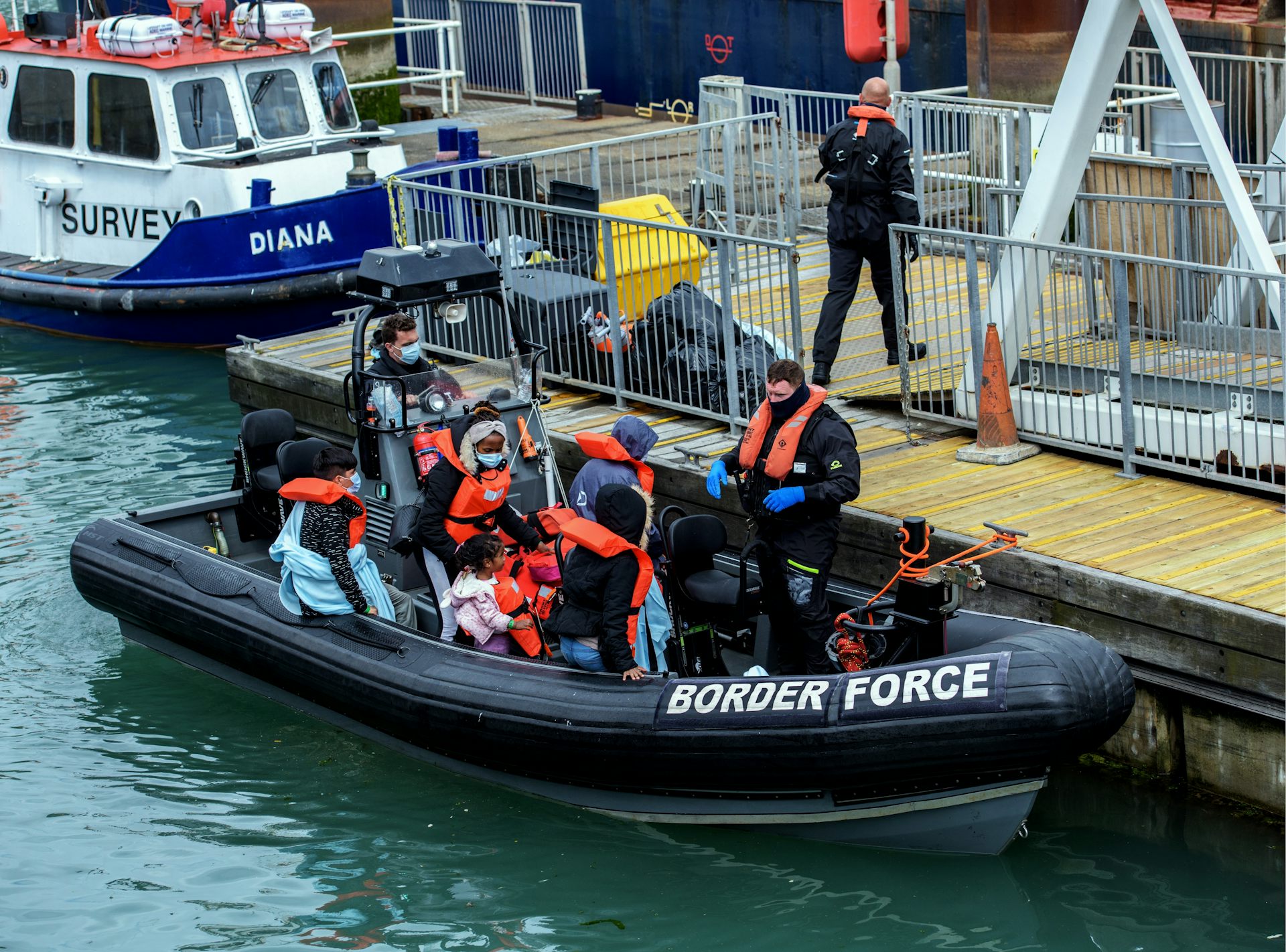 A border force boat carrying people thought to be refugees arrives at a dock in Dover