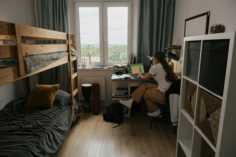 A person at a desk working near a window.