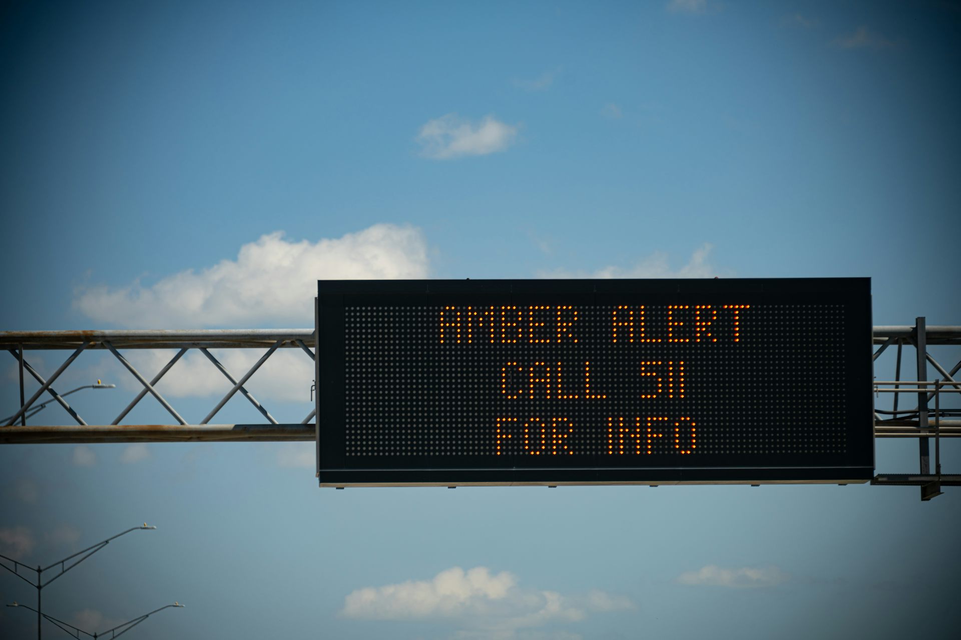 A digital sign with lights that spell out 'Amber Alert Call 511 for Info'