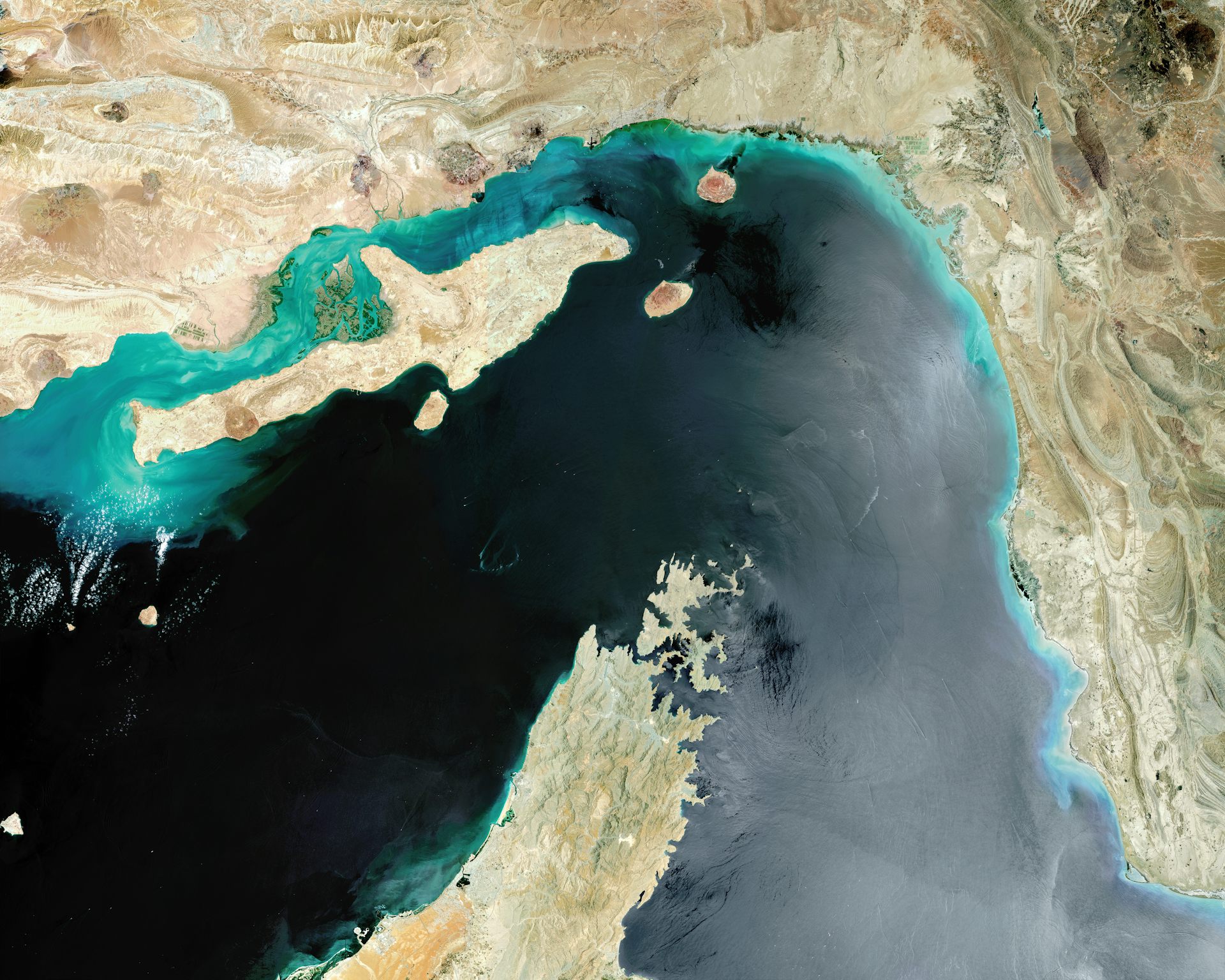 a satellite view of water flowing between two land masses
