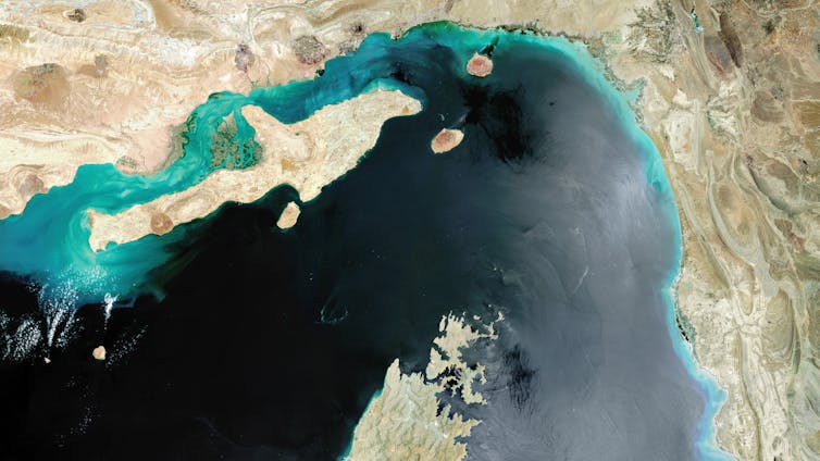 a satellite view of water flowing between two land masses