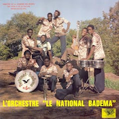 An album cover showing a large band of African musicians posing with a drum kit