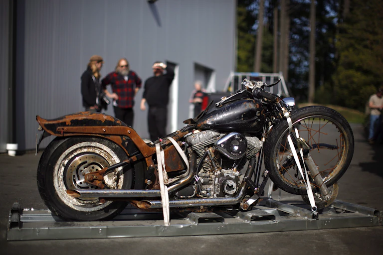 an old motor bike on a platfom