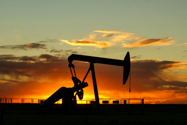 oil pump silhouetted against a sunset.