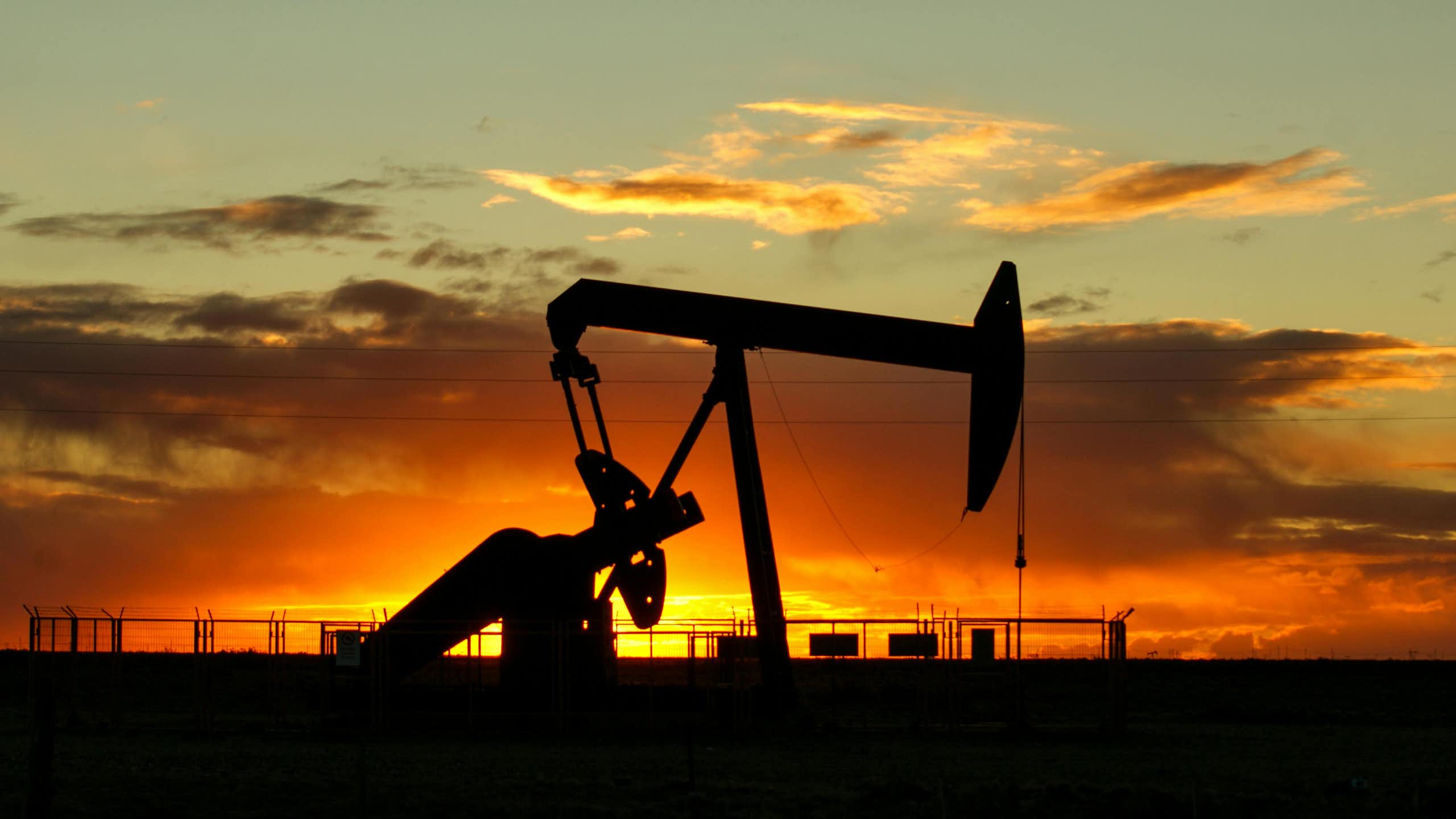 oil pump silhouetted against a sunset.