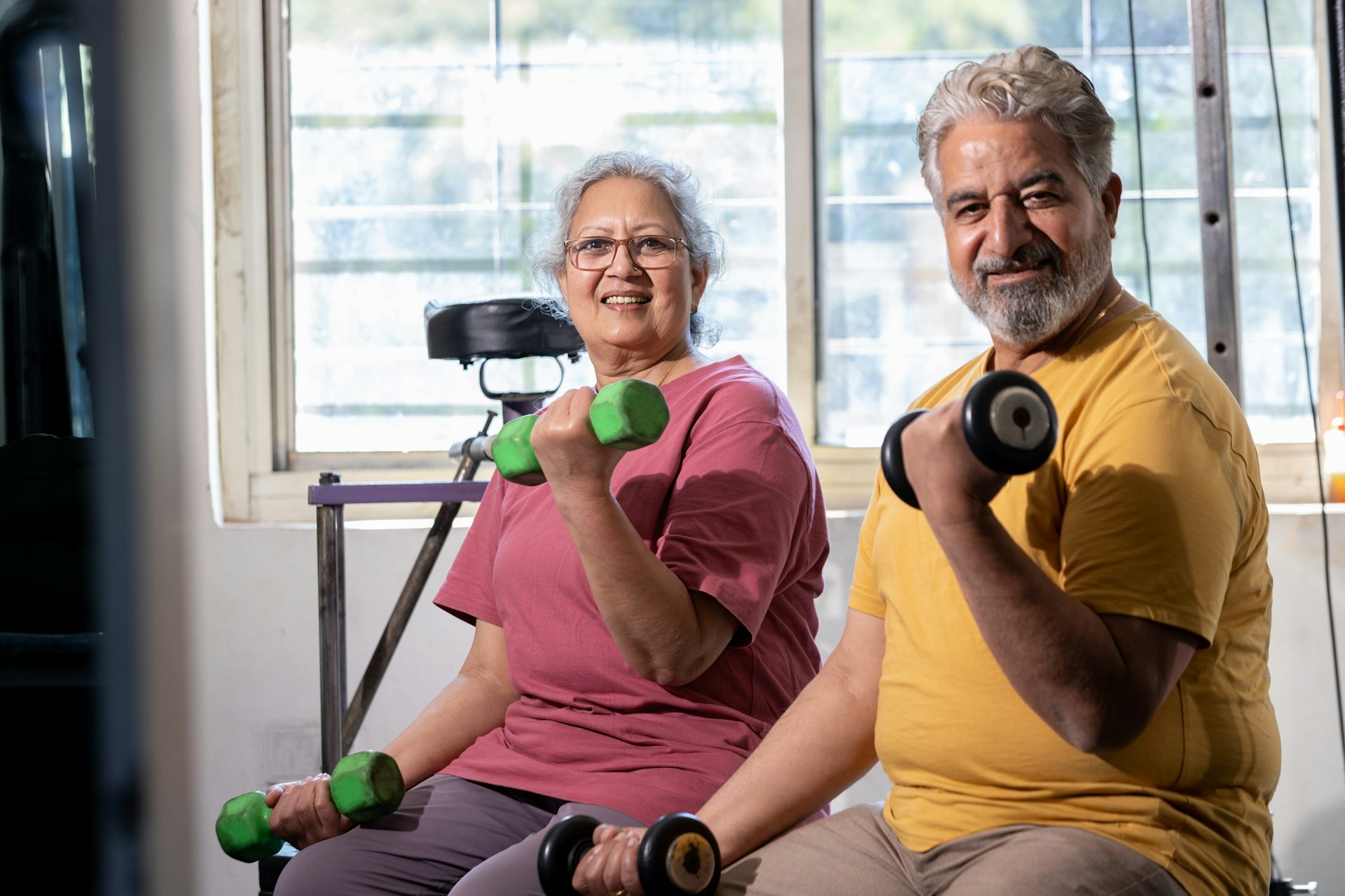 Senior couple strength training with dumbells