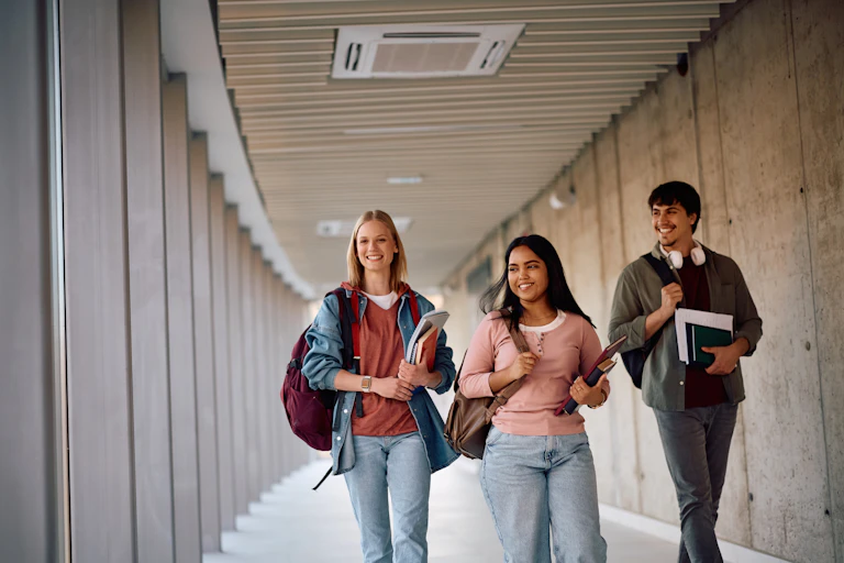 Happy students walking at university