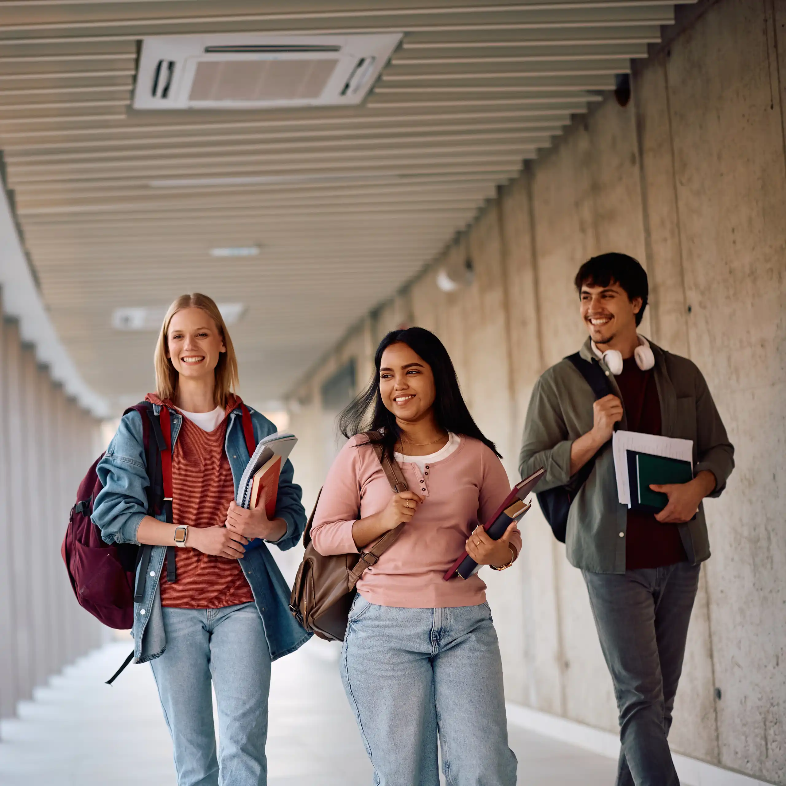 Happy students walking at university