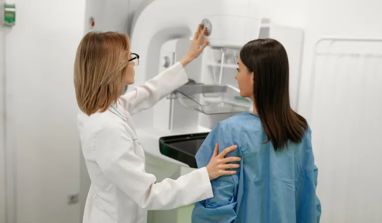 A woman receiving a mammogram.