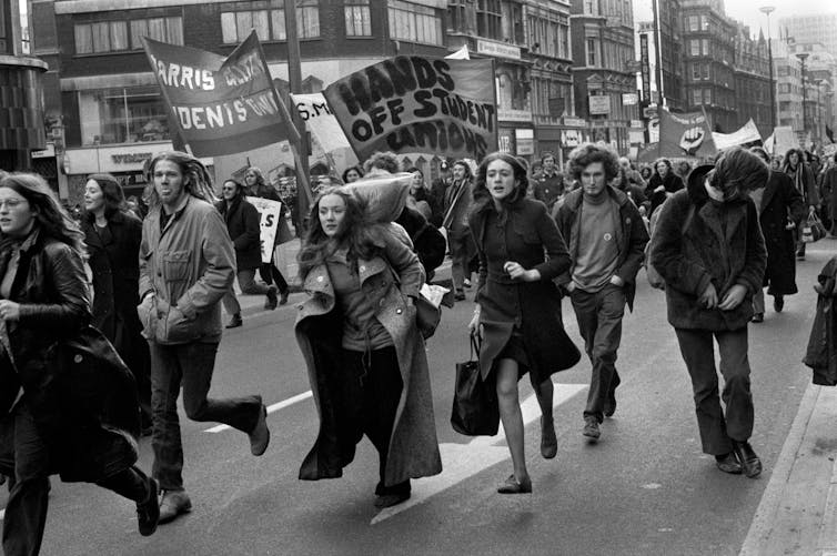 Black and white photo of students with placards