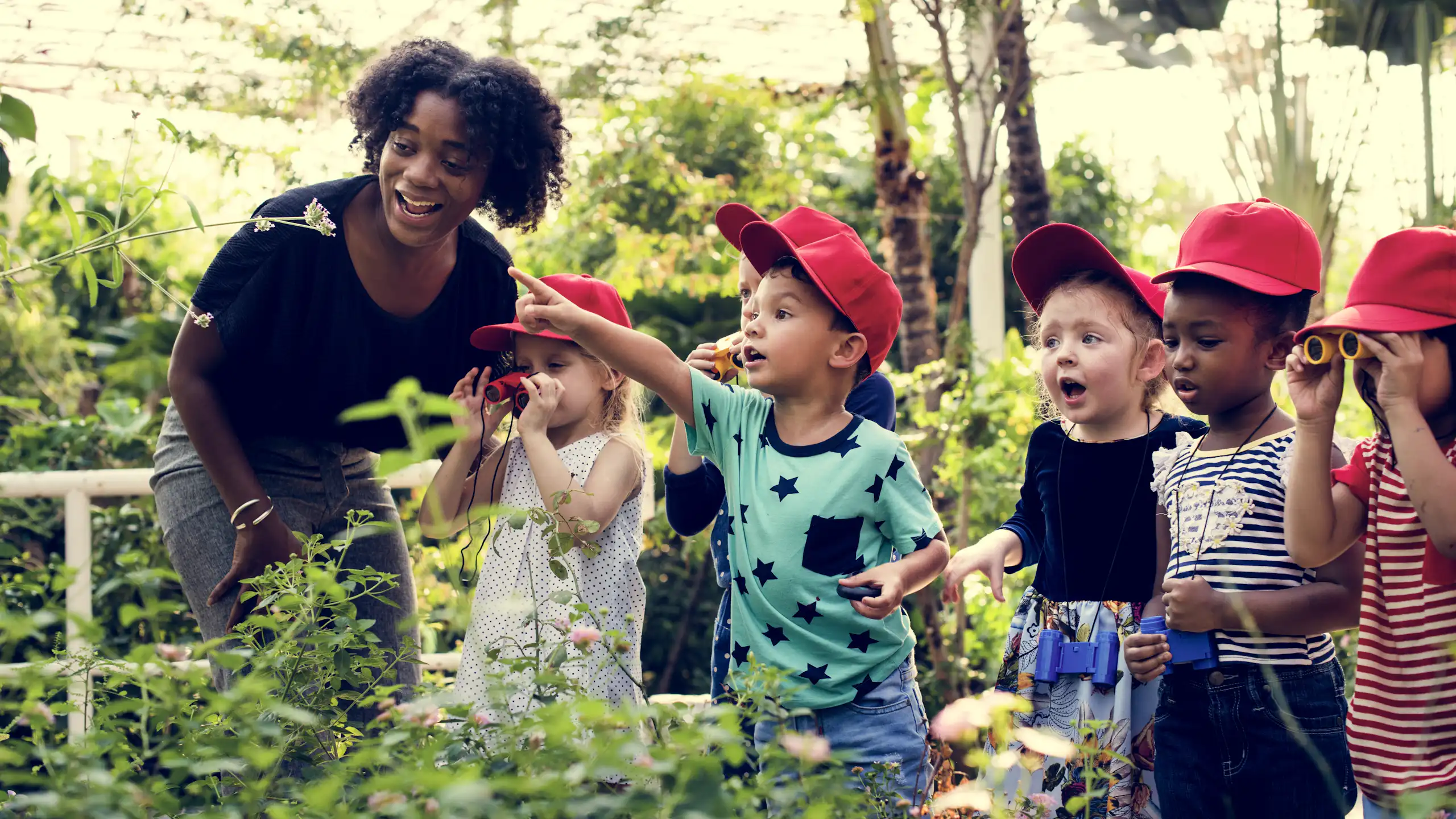 Teacher and children looking at plants