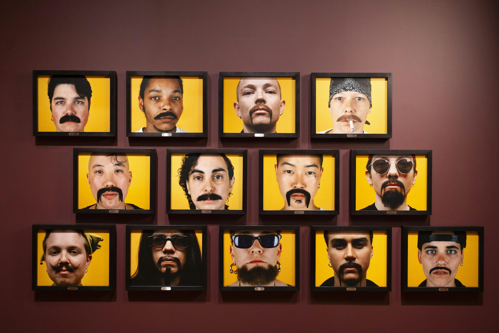 photos of faces on a wall