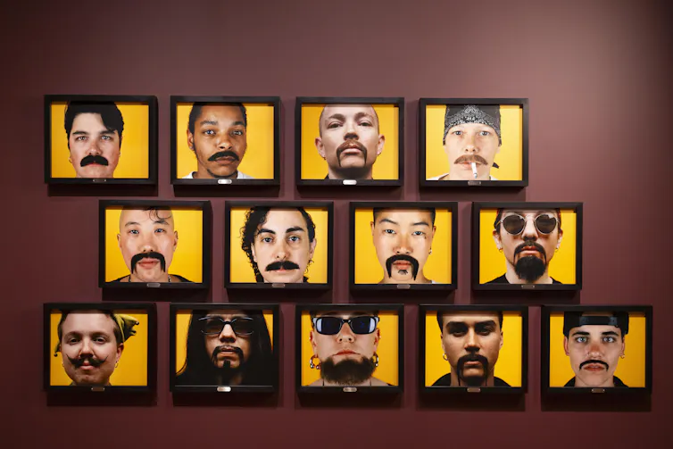 photos of faces on a wall