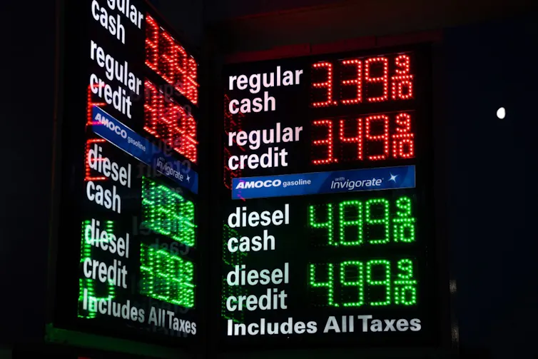 electronic display showing petrol and diesel prices at a new york filling station.