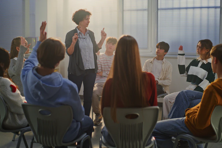 Teacher and circle of students in discussion