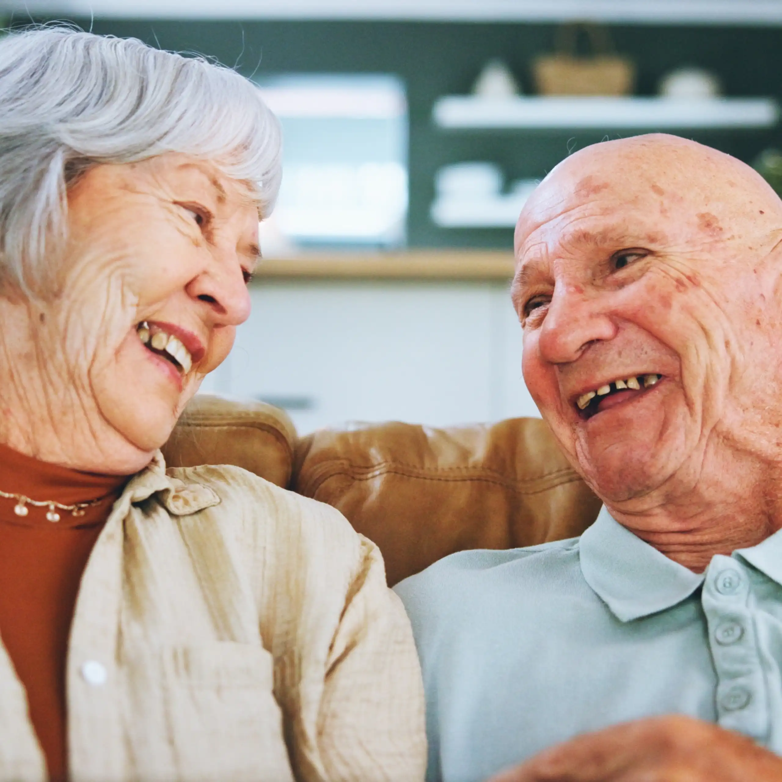 An older worman and man laughing together.