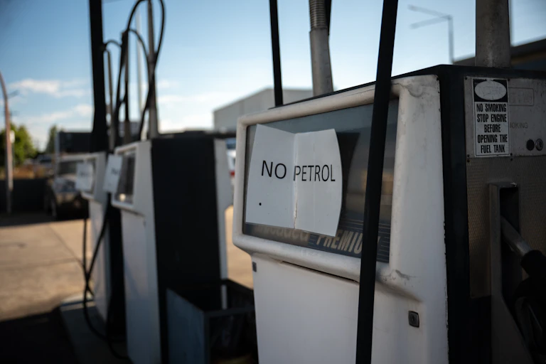 Empty fuel pumps at a service station, sign which reads no petrol