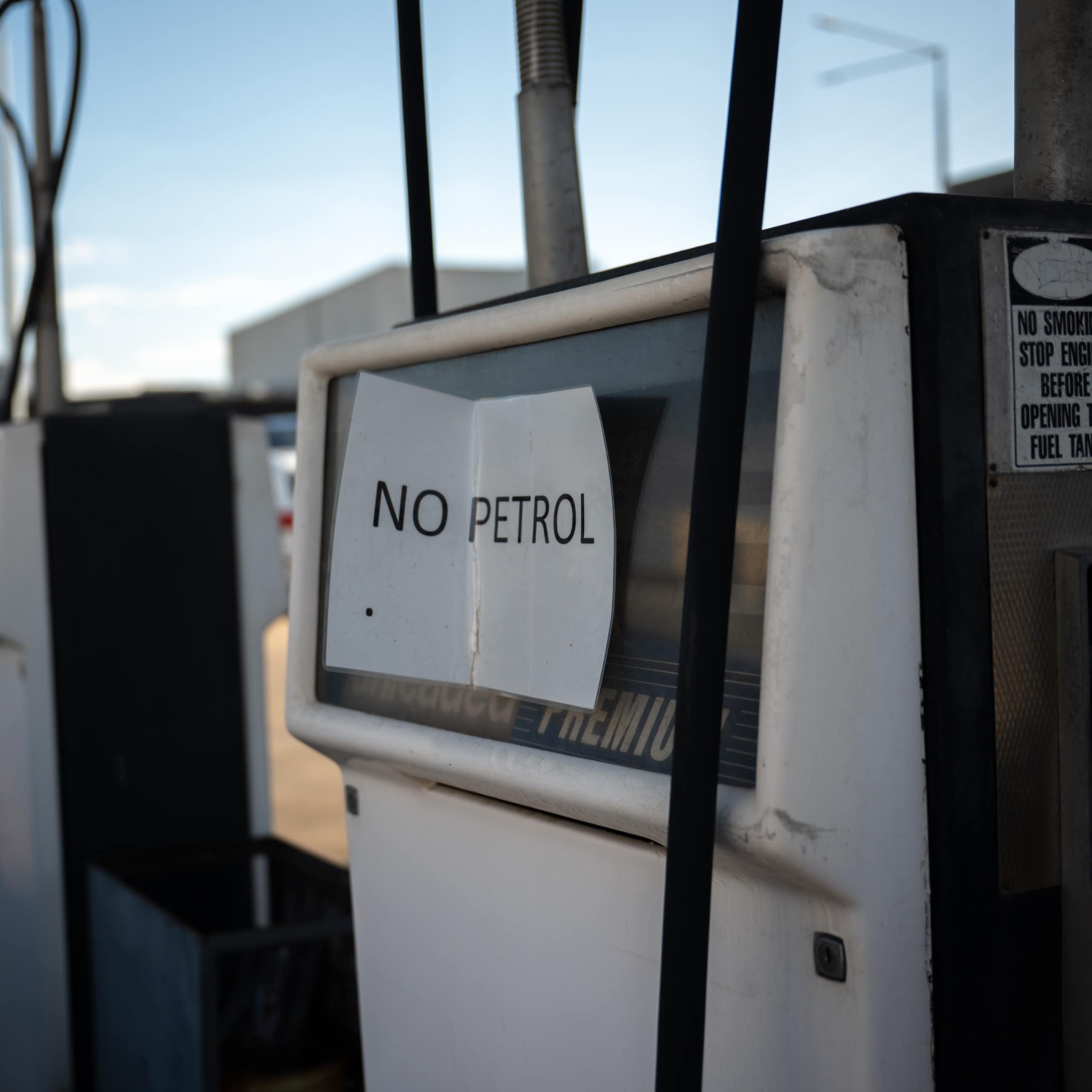 Empty fuel pumps at a service station, sign which reads no petrol
