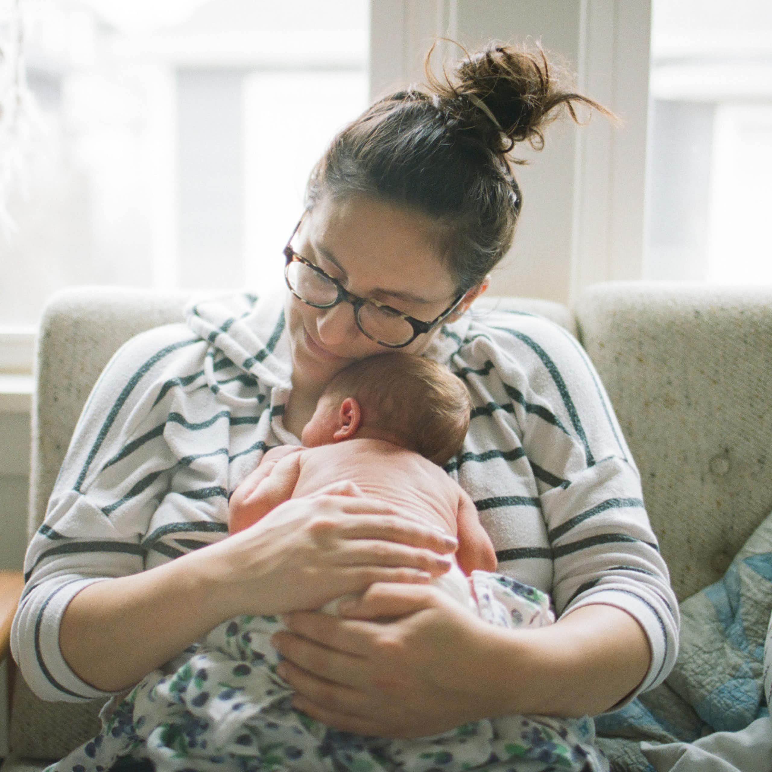 Woman cuddling little baby.