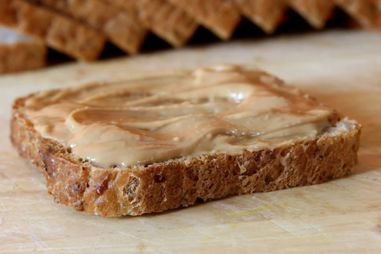 Peanut butter spread thickly on brown or wholemeal bread.