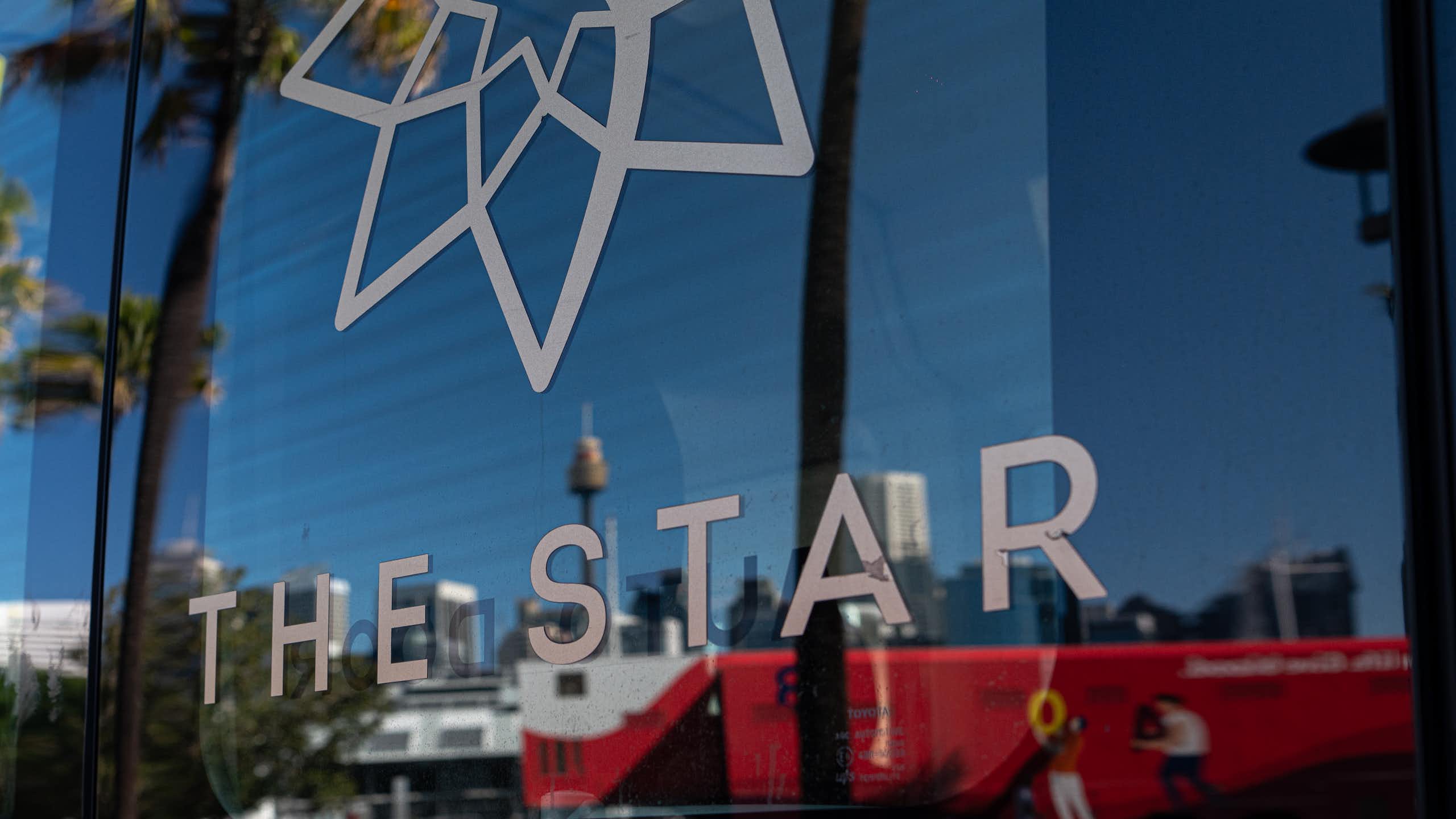 A close up of Sydney's Star casino logo, with the Sydney's skyline in the background