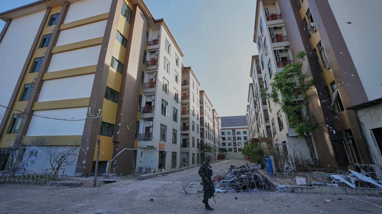 A Thai soldier keeps guard outside a scam center in O'Smach, Cambodia.