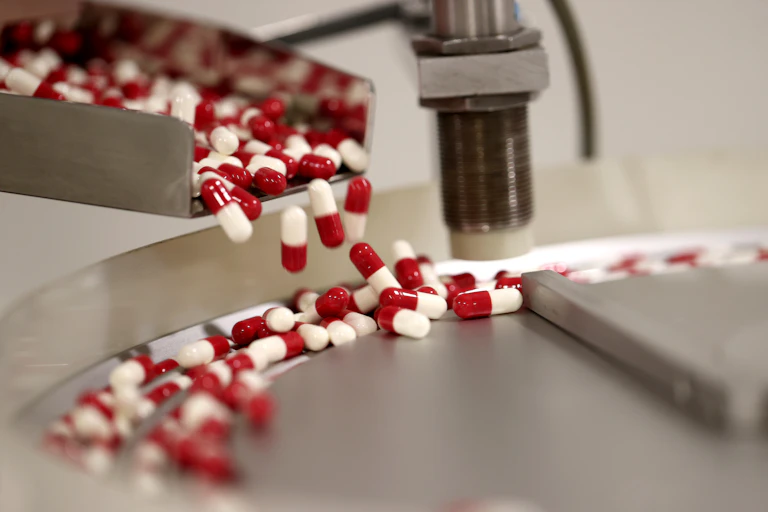 Red and white capsules in a production line