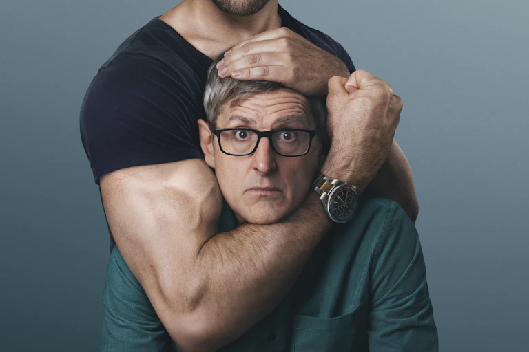 A speccy nerdy-looking guy in a headlock by a guy with massive muscles.
