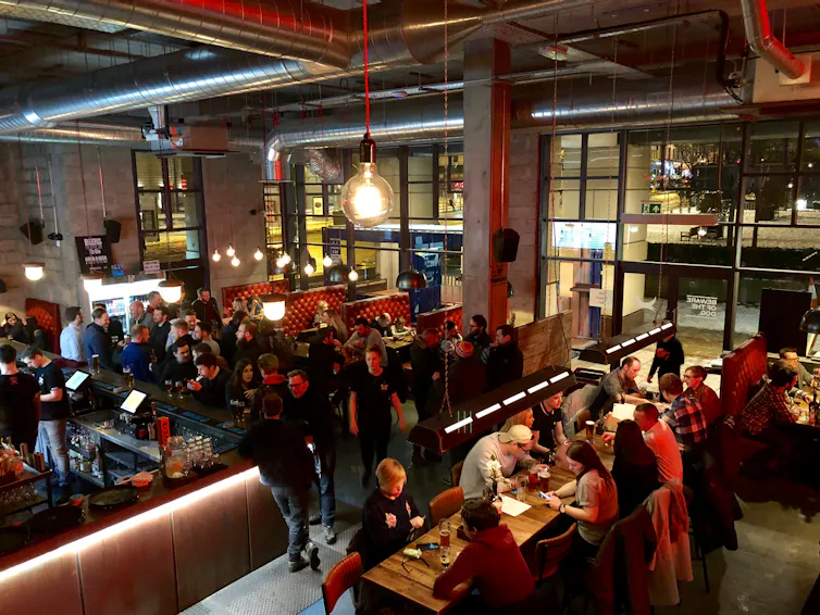 interior of brewdog pub filled with drinkers and diners.