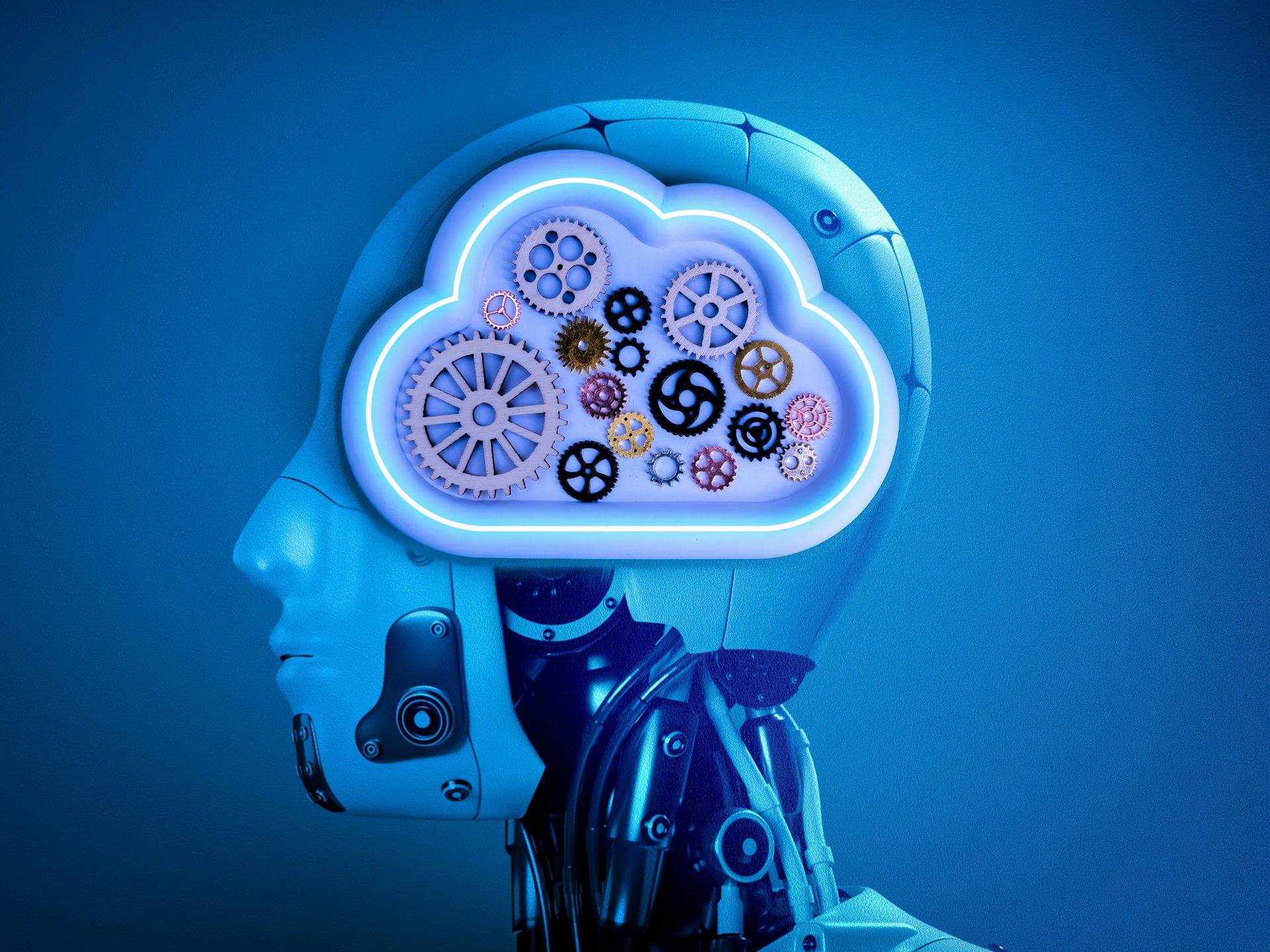 El cap d'un robot amb un cervell transparent fet de múltiples peces de mides i colors diferents.