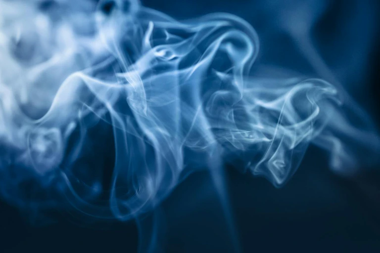 White smoke against dark blue/black background