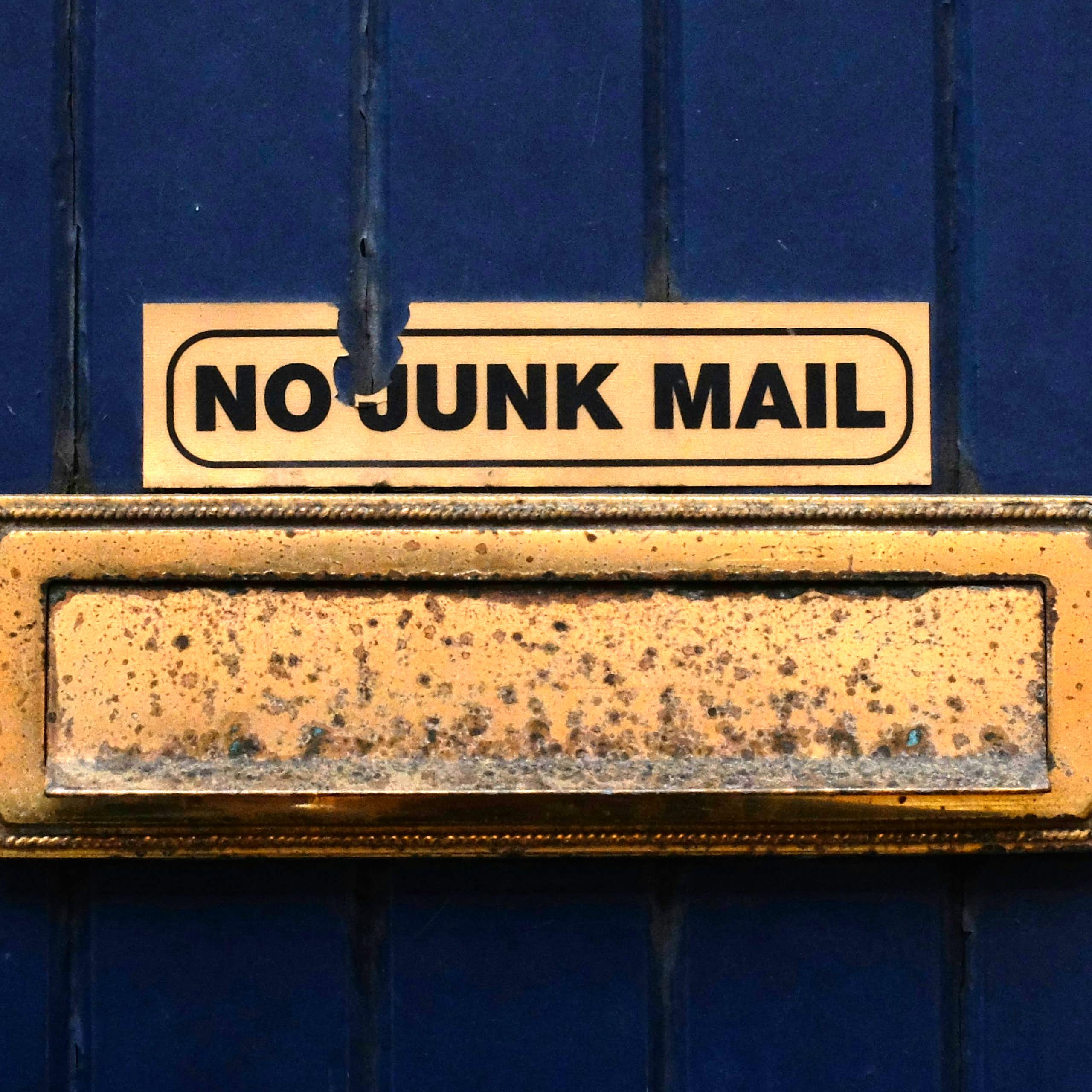A no junk mail sign above a door's letterbox