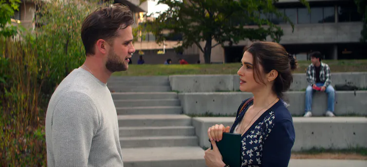 a man and woman look at each other