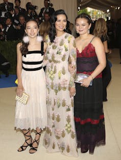 two young women with their mother, all in evening dress